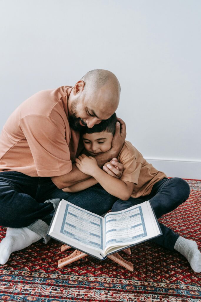Heartwarming moment of father and son hugging while reading a book together, showcasing love.